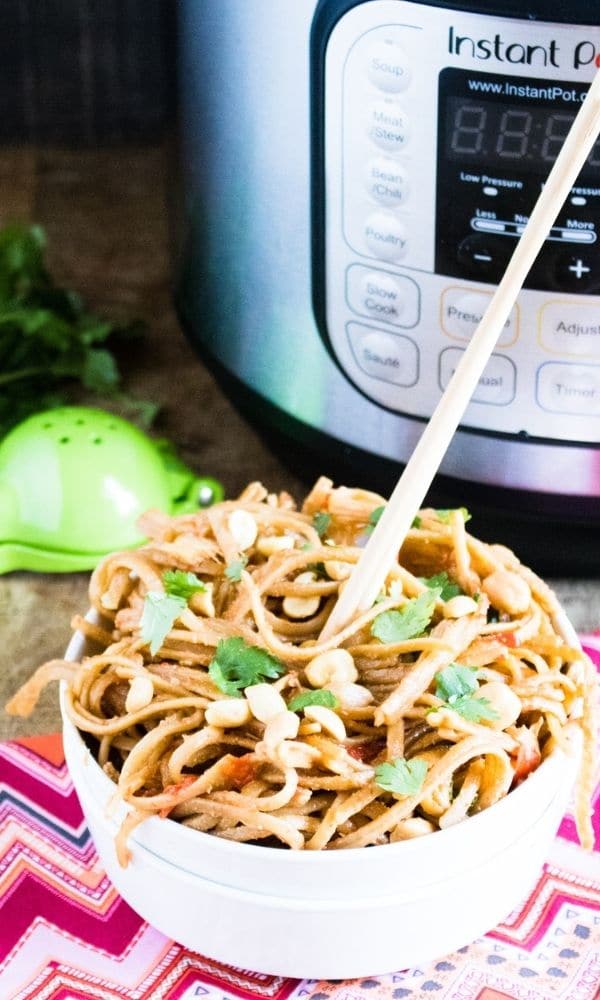 bowl of pasta with chopsticks sticking out 