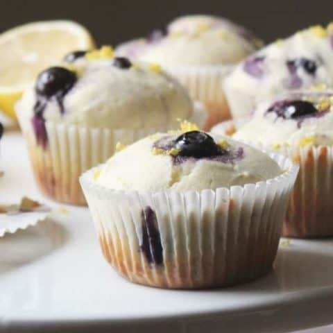 blueberry lemon muffins on a cake stand