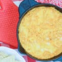 buffalo chicken dip in a pan next to bowl of chips