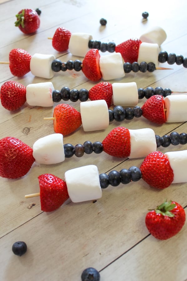 fruit skewers that are red white and blue themed