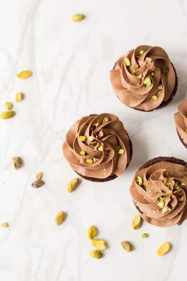 Homemade Nutella Cupcakes with Chocolate Buttercream Pistachio frosting. Light and moist chocolate cupcakes with a homemade buttercream frosting. #cupcakes #chocolate #stuffedcupcakes #summercupcakes #buttercreamfrosting #pistachio #hazelnut #homemade #easy homemade cupcake recipe