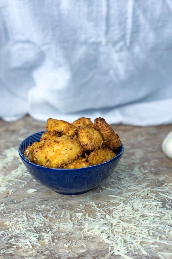 garlic parmesan chicken nuggets in a bowl on counter