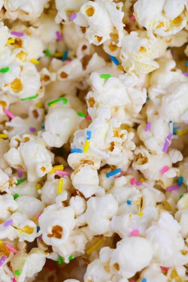 marshmallow popcorn with sprinkles over it 