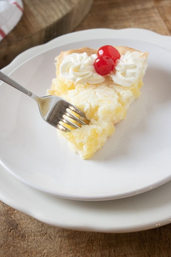 Pineapple pie is a tropical pie that is perfectly sweet. Pineapple pie recipe is easy to make, great for entertaining, and unique. #pie #pineapple #crushedpineapple #whippedcream #cherry #easy #recipe #homemade #party #dessert #tropical canned pineapple pie