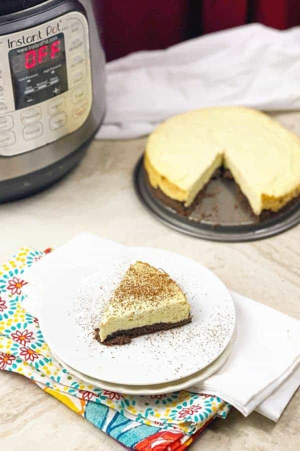 instant pot keto cheesecake on a plate with cheesecake behind it