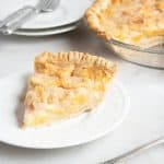 slice of peach pie on a white plate