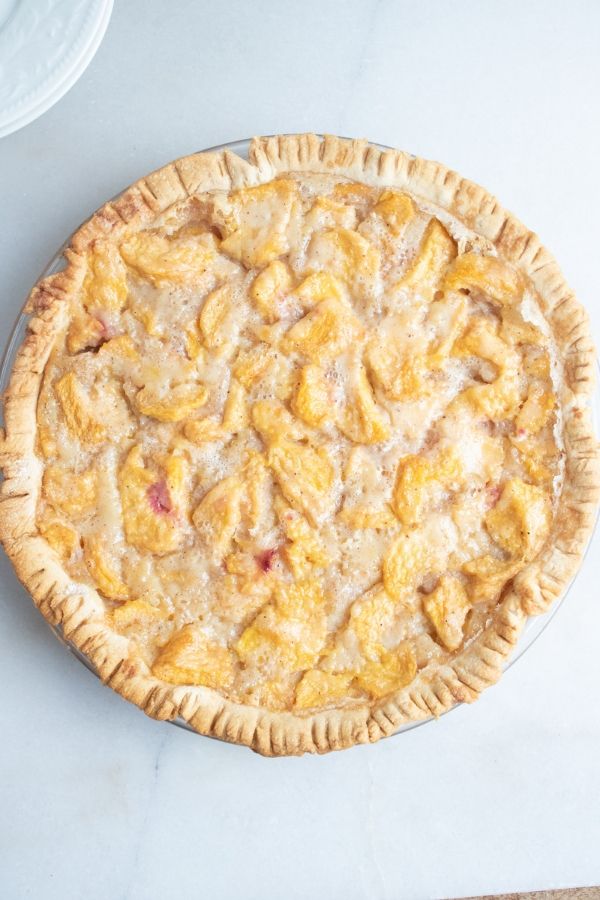 whole peach pie on counter 