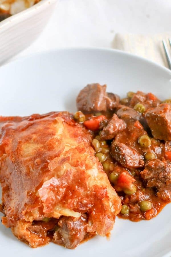 beef pot pie on a white plate on table