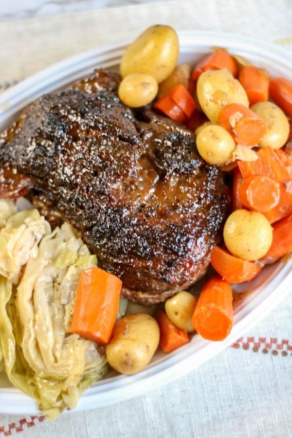 ninja corned beef and vegetables on a white platter on the table 