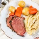 corned beef on a plate with cabbage and vegetables
