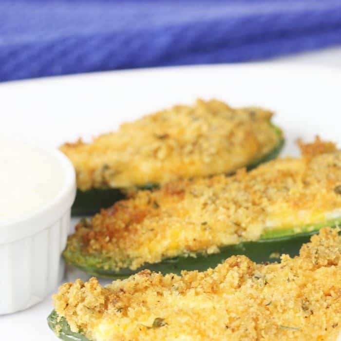 breaded jalapeno poppers on a plate with ranch dressing in a bowl 