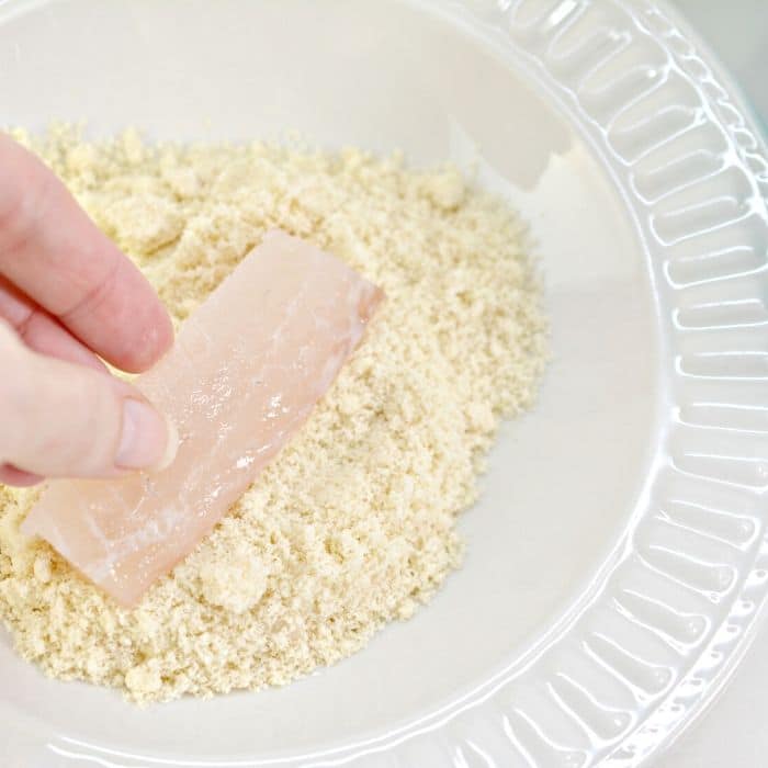Dredging fish in almond flour 