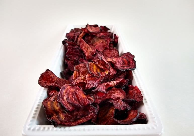 beet chips on platter on a white counter 