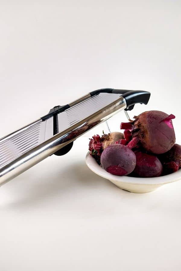 mandolin sitting by a bowl of beets 