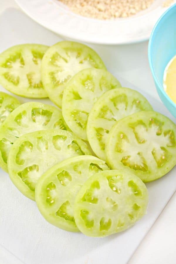 sliced green tomatoes on cutting board 