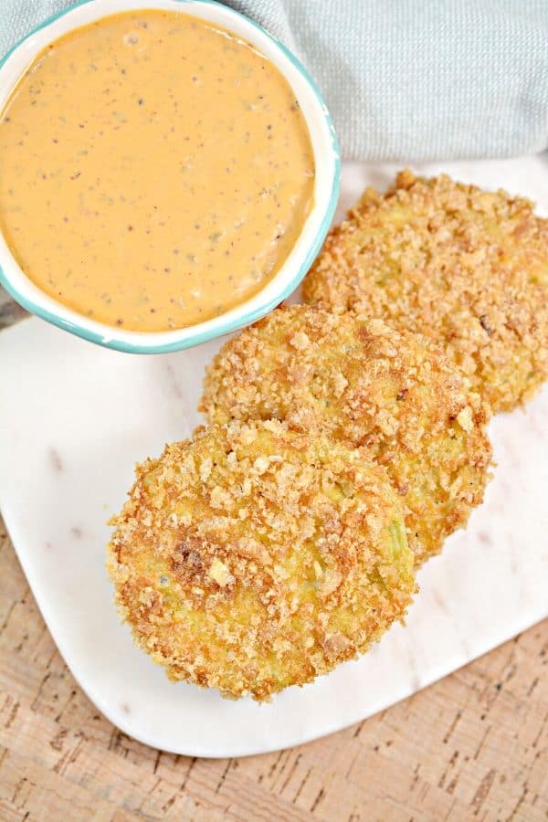 fried green tomatoes on plate with sauce by it 