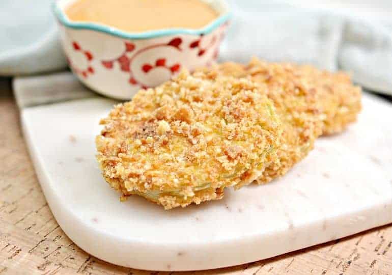 pork rind fried green tomatoes on marble cutting board 