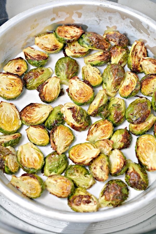 crispy brussel sprouts in a metal pan 