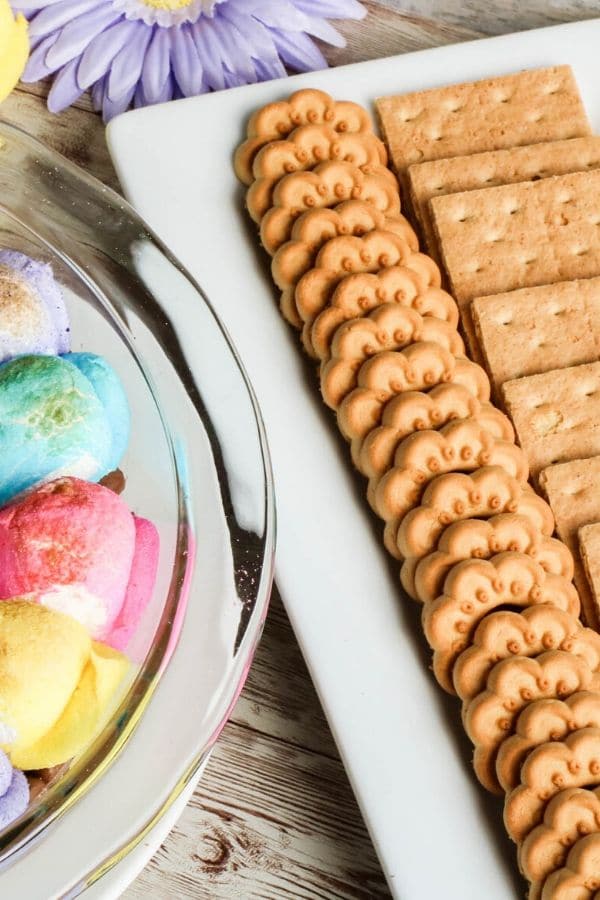 cookies on a plate next to a warm s'mores dip