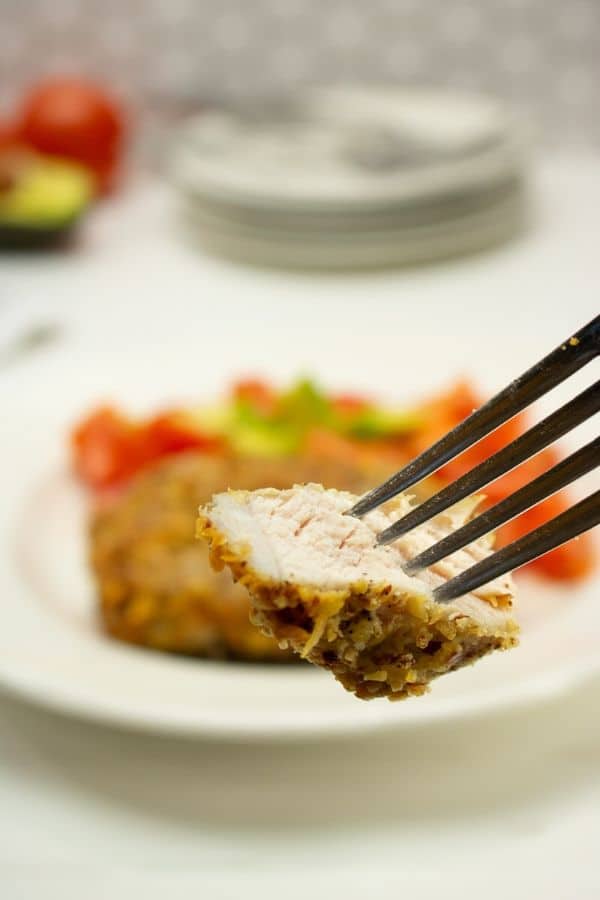 bite of pork chop on a fork 