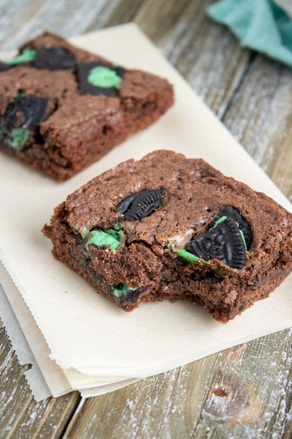 mint oreo brownie with bite taken out sitting on table 