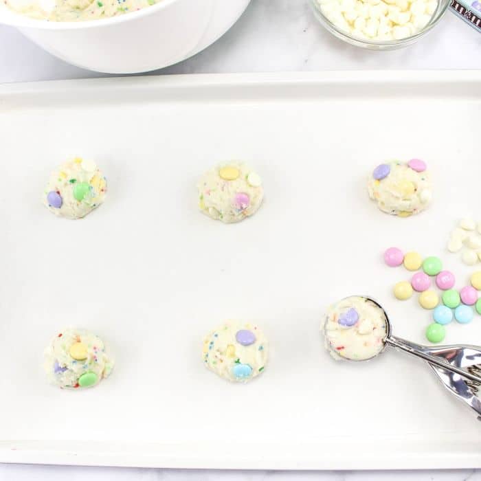 cookies scooped out on a baking sheet with a cookie scoop