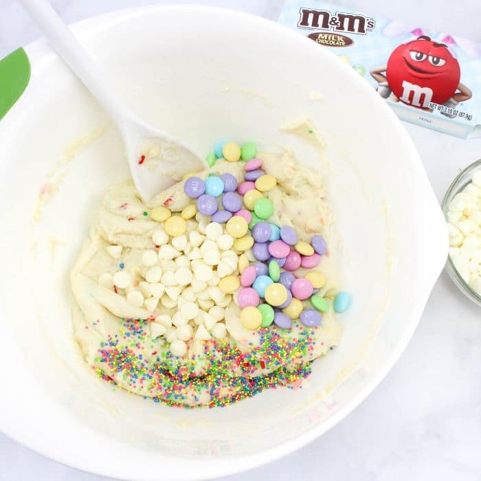 mixing bowl with cookie dough and Easter M&M's in a white plastic bowl 