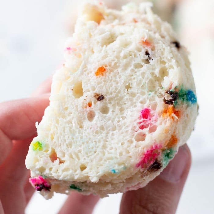 holding a slice of funfetti angel food cake 