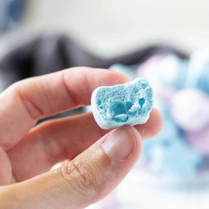 holding a dried blue marshmallow