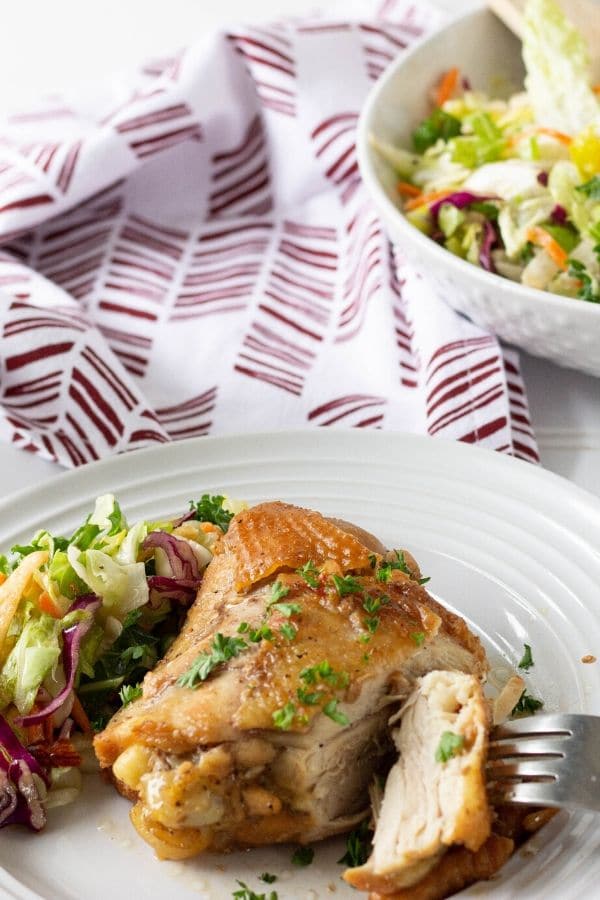 chicken dinner on plate with salad