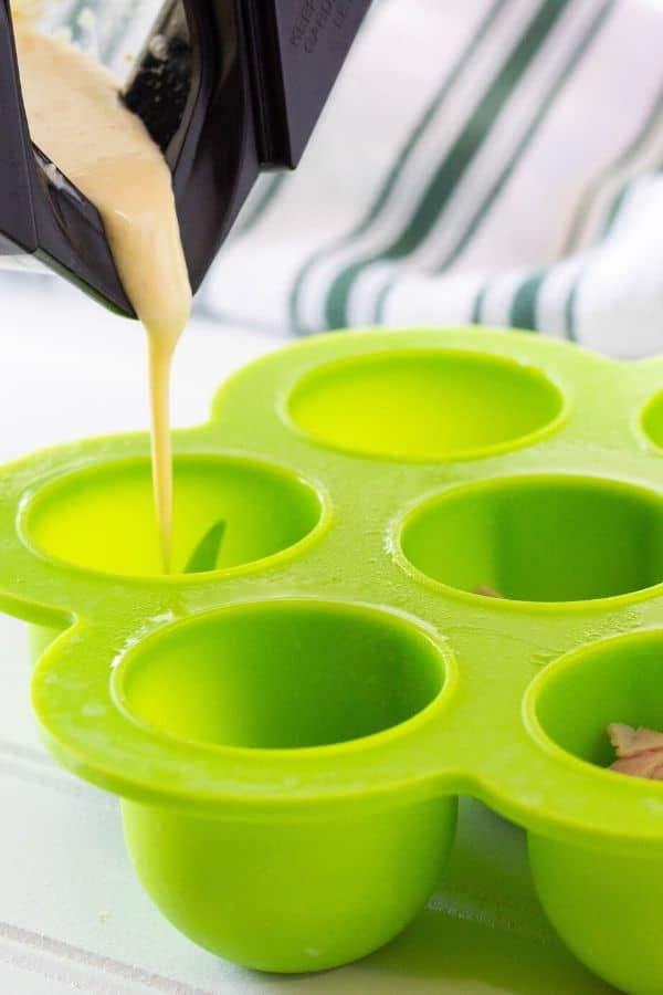 pouring egg mixture into egg bite mold