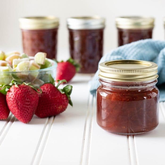 homemade jam on table with fruit on side 