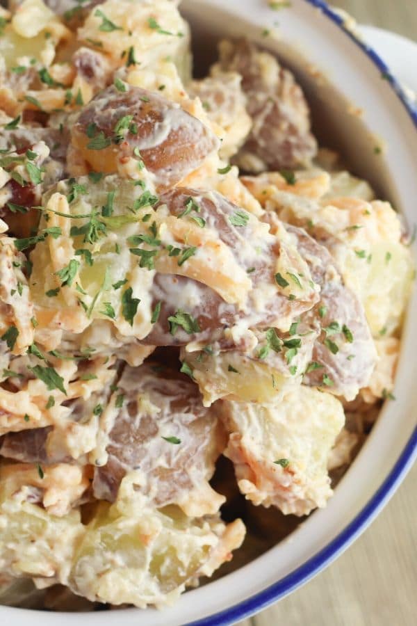 close up view of cheesy potato salad in bowl 