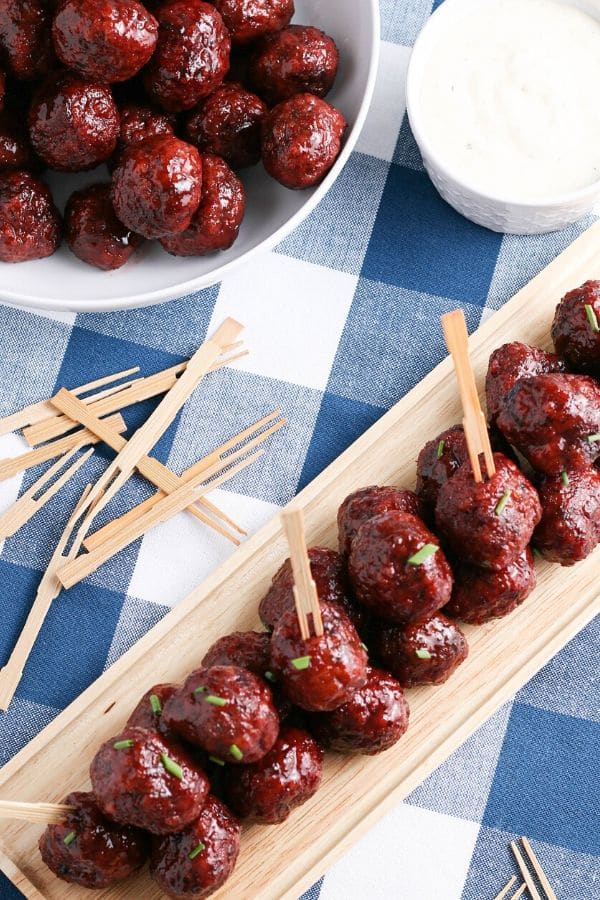 tray on counter with meatballs with toothpicks in it 