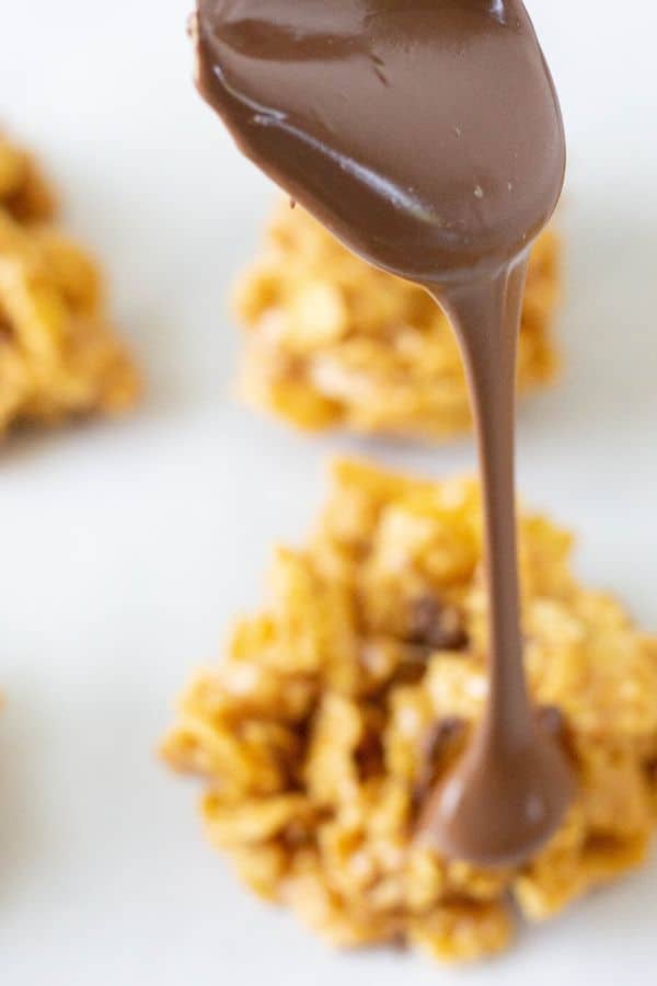 pouring chocolate over the top of a cookie 