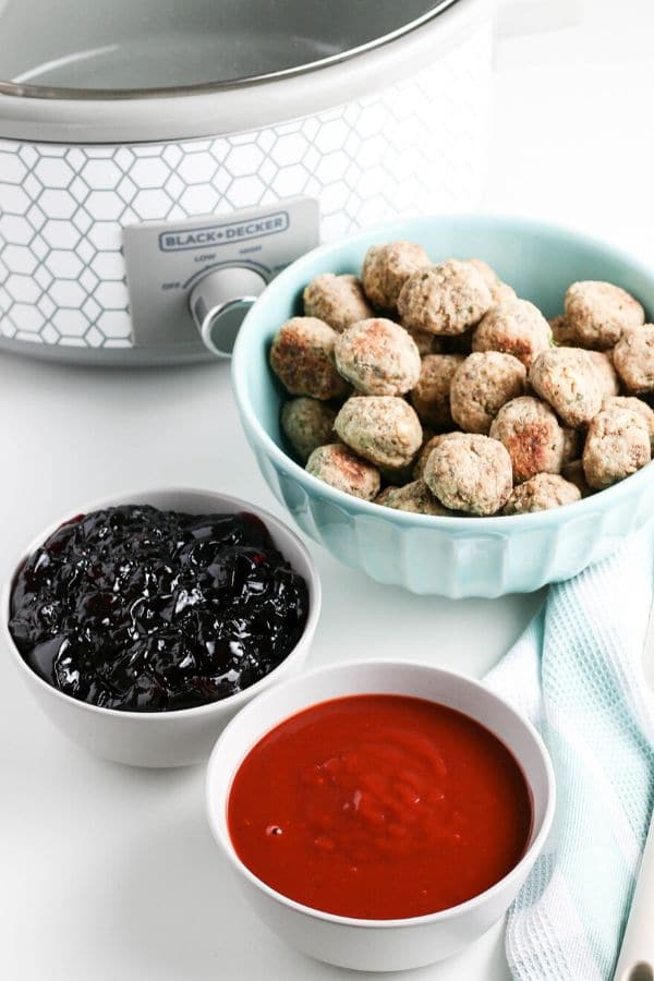 meatball appetizer with ingredients by it in a bowl 