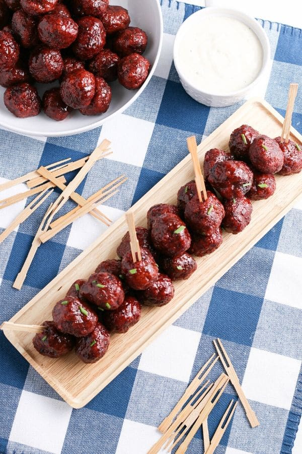 grape jelly meatballs on a platter with toothpicks