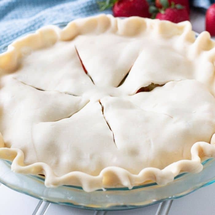 pie with raw pie crust on top with slits in top for air holes