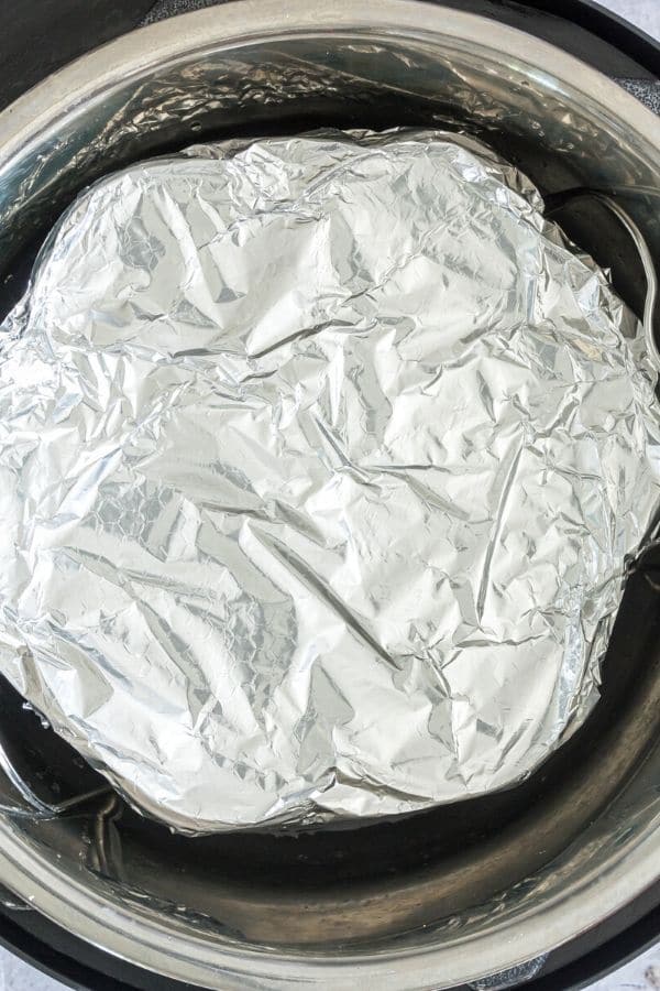 egg bite mold covered in aluminum foil in Instant Pot 