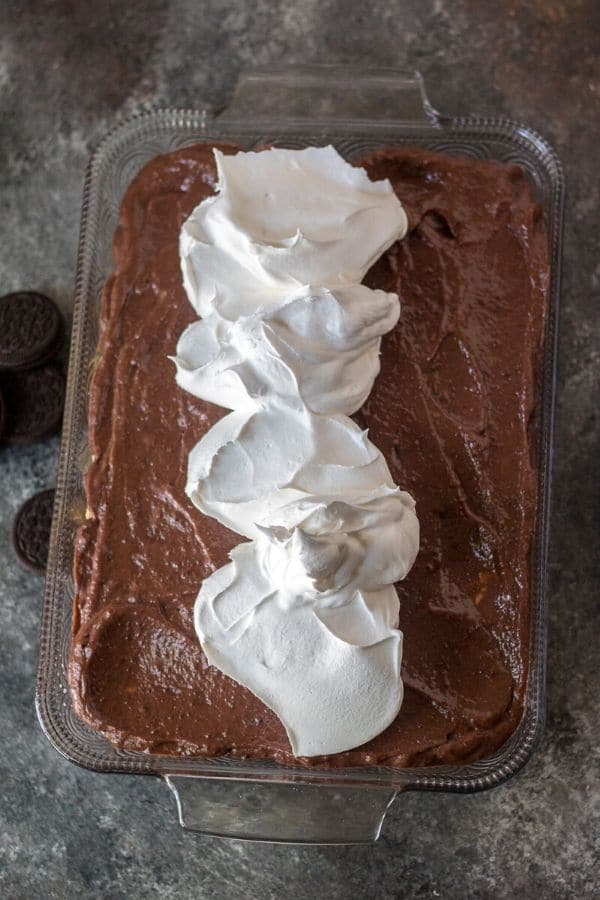 whipped cream on top of chocolate pudding in cake pan 