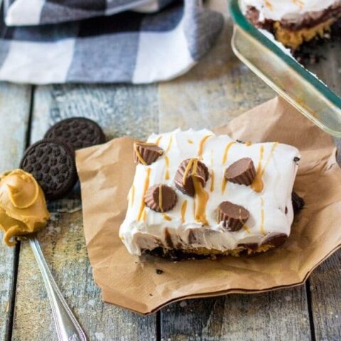 peanut butter lush on table with spoon of peanut butter and Oreos by it