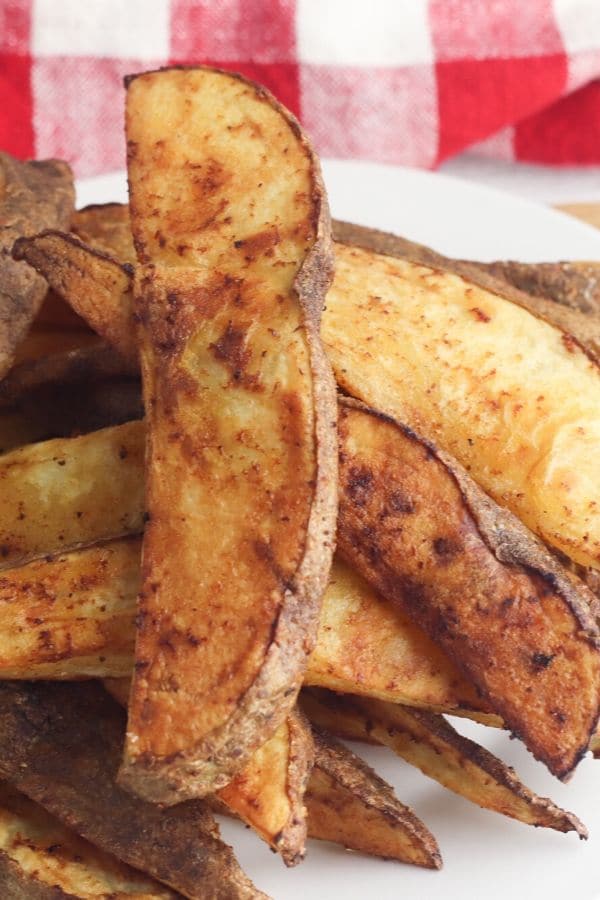 potato wedges on a plate stacked up