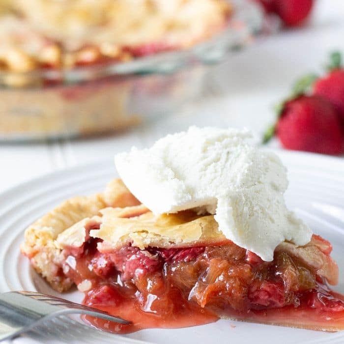 strawberry rhubarb pie on plate with ice cream