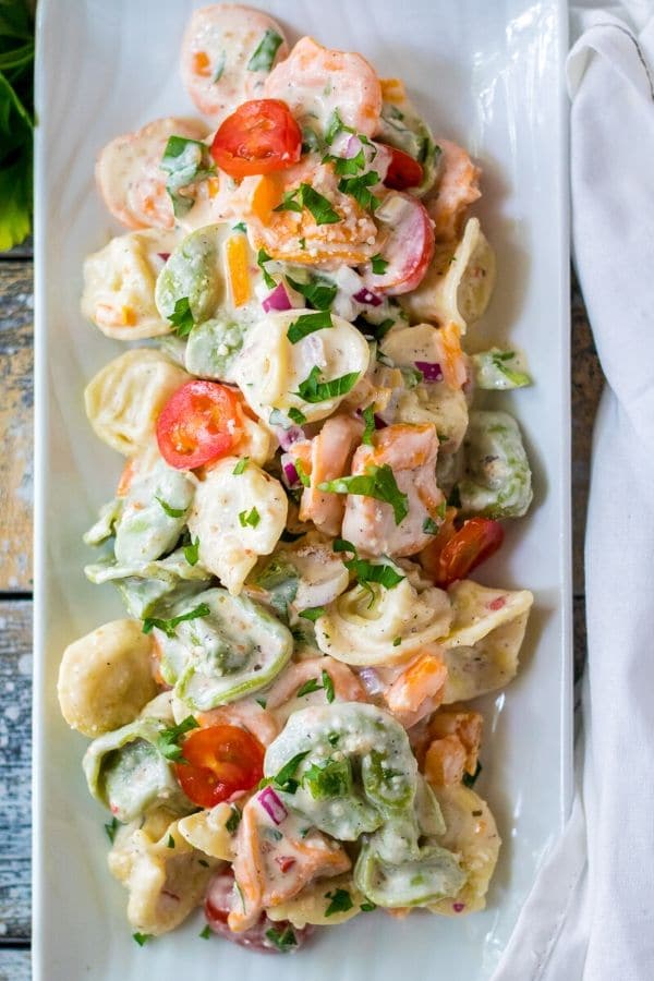 tortellini salad on a rectangle white platter