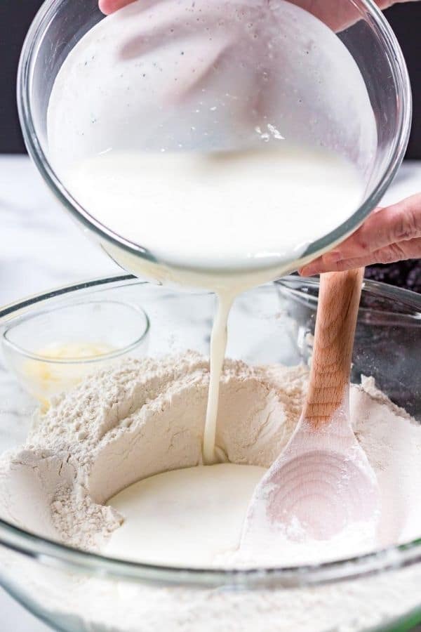 flour mixture with buttermilk being poured in