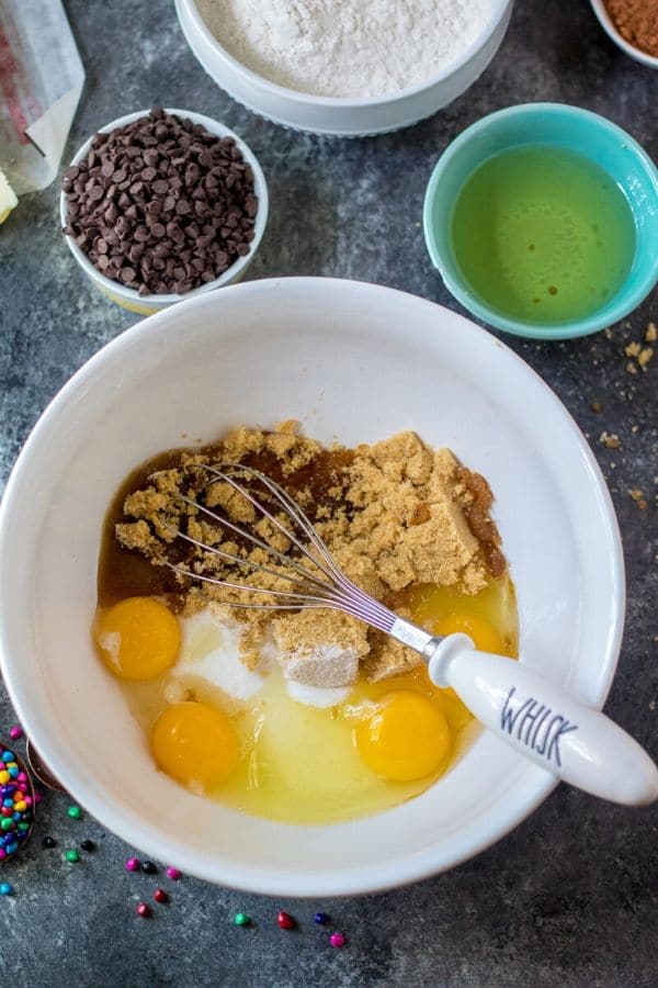 bowl with brownie ingredients in and food around it 