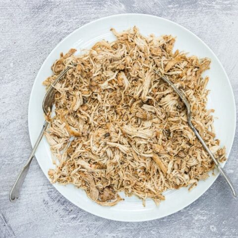 shredded chicken on a plate with two forks