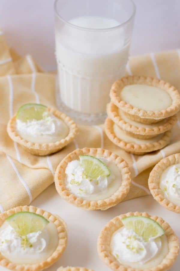 lime pies on table with milk by it