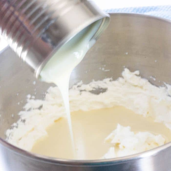 pouring sweetened condensed milk in bowl 