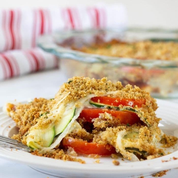 tomato bake stacked on a plate with fork by it 